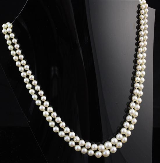 An early 20th century double strand graduated cultured pearl necklace with circular diamond cluster clasp, 16.5in.